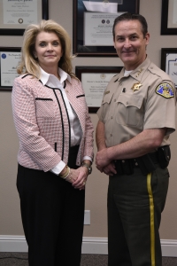 Michelle Simoes poses for a photo with Sheriff Mike Boudreaux following her swearing in as the new Sheriff's Pilot at the Tulare County Sheriff's Office.