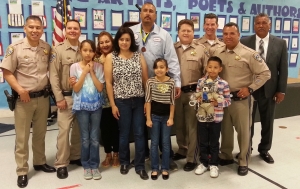 Ruben Mendoza (in the blue), with the family of Ricardo Carrillo, and CHP Officers.