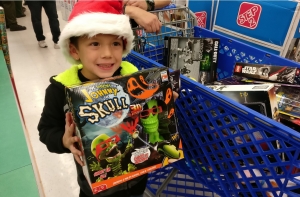 7 year old Joseph clutches the toy he's selected for his haul.